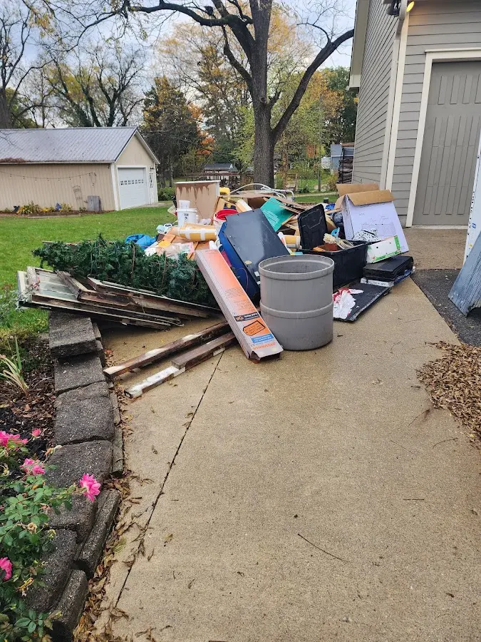 Dumpster being loaded with debris for Estate Cleanout Dumpster Rental in Upper Milford